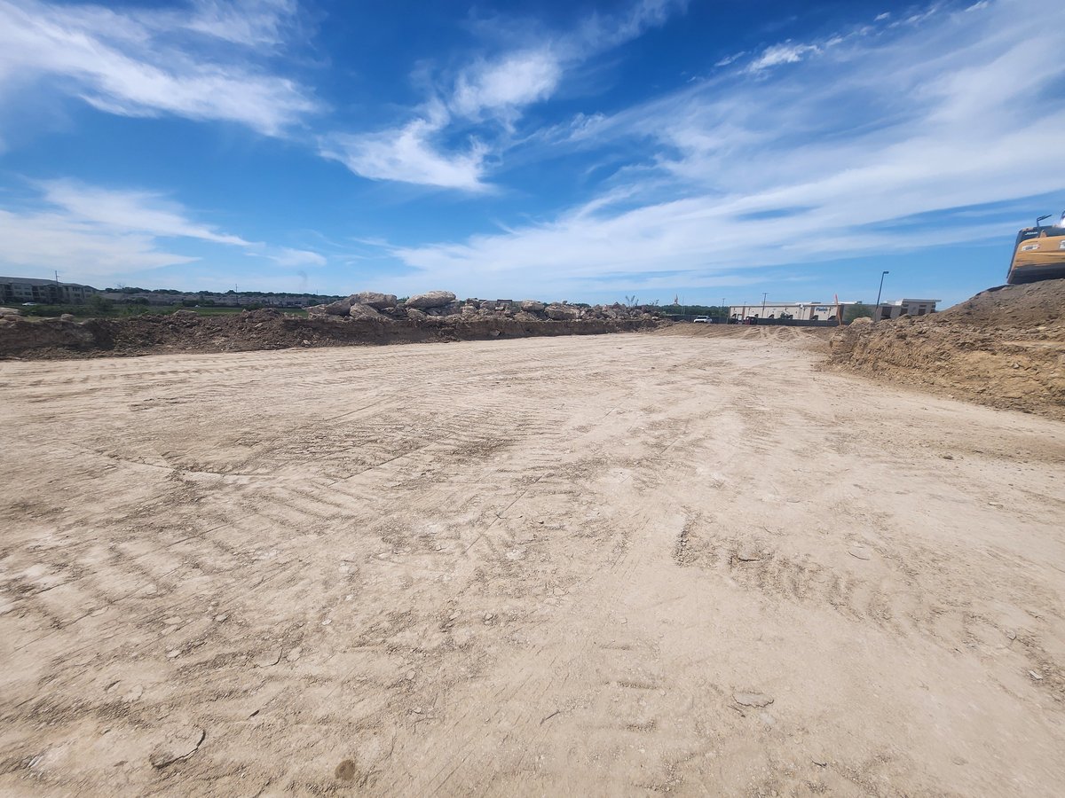 Commercial site prep and grading on a large pad in Bryan, Texas