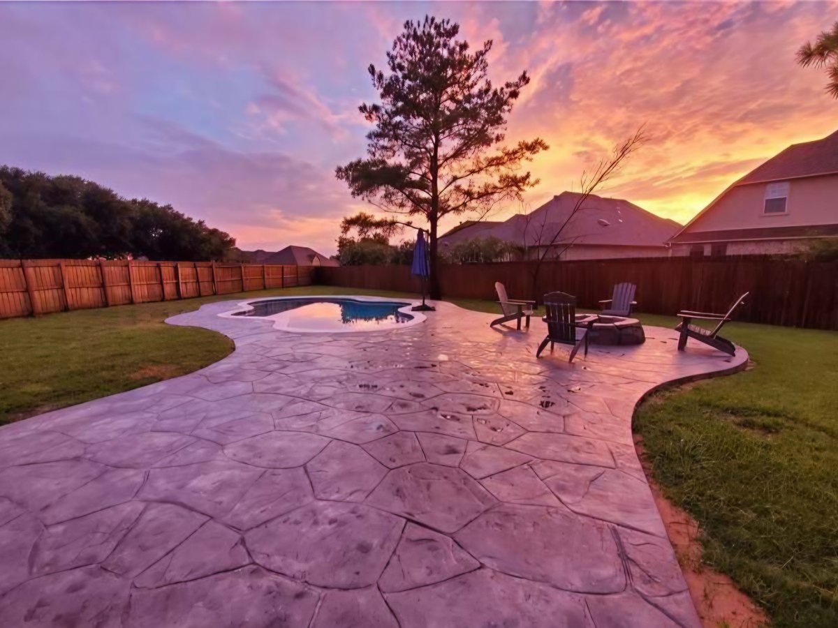 Stamped concrete pool deck patio at sunset in College Station, Texas