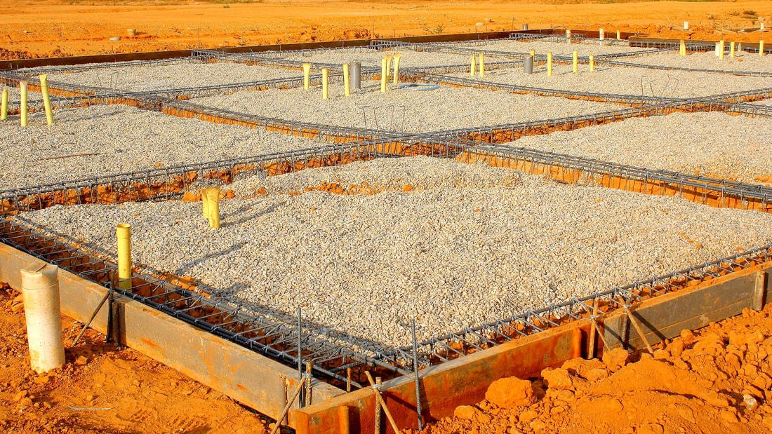 Custom residential home foundation with plumbing rough-in and steel in place